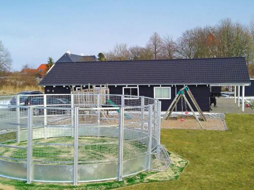 a playground in front of a house at Luxury Retreat with Pool - By Traum Ferienwohnungen in Høruphav