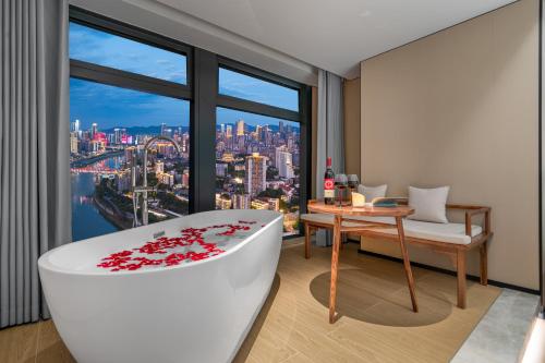 a room with a tub and a table with a view at Chongqing Xingcheng Chengyijing Hotel Management Co., Ltd in Chongqing