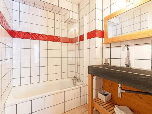 a bathroom with a tub and a sink at Chalet in Peisey near Ski Lift in Peisey-Nancroix
