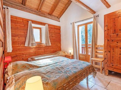 a bedroom with a bed in a room with wooden walls at Chalet in Peisey near Ski Lift in Peisey-Nancroix