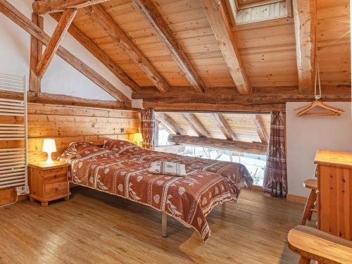 a bedroom with two beds in a room with wooden ceilings at Chalet in Peisey near Ski Lift in Peisey-Nancroix