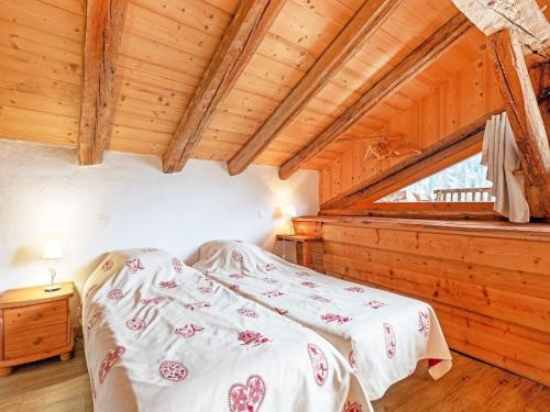 a bedroom with a bed in a wooden cabin at Chalet in Peisey near Ski Lift in Peisey-Nancroix