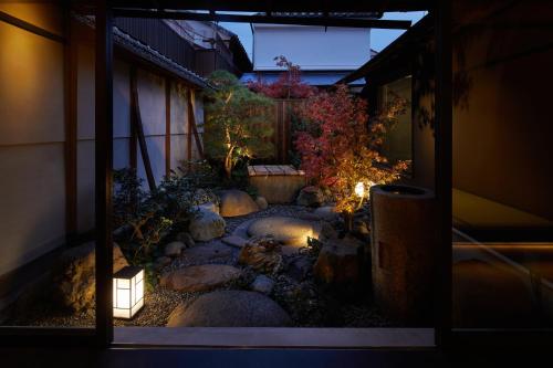 a view of a garden at night from a window at Enso Machiya in Kyoto