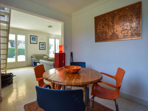 a dining room with a wooden table and chairs at Beachside Brittany Escape in Pénestin