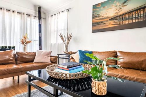 a living room with a couch and a coffee table at Spacious 4 bedroom home by Melrose and 10 minutes to Hollywood Walk of Fame in Los Angeles