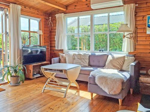 a living room with a couch and a table at 6 person holiday home in Lemvig in Lemvig