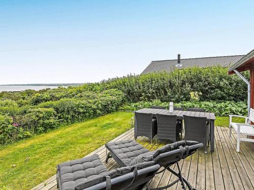 a deck with two chairs and a table on it at 6 person holiday home in Lemvig in Lemvig
