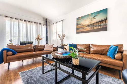 a living room with a couch and a table at Spacious 4 bedroom home by Melrose and 10 minutes to Hollywood Walk of Fame in Los Angeles