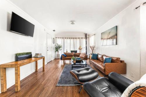 a living room with a couch and a table at Spacious 4 bedroom home by Melrose and 10 minutes to Hollywood Walk of Fame in Los Angeles