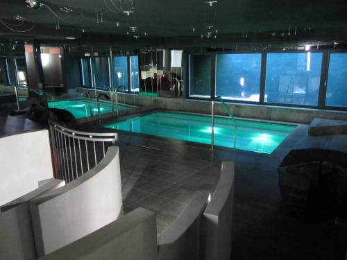 a large swimming pool in a building with aperature at Hotel Alla Posta in Saint Vincent