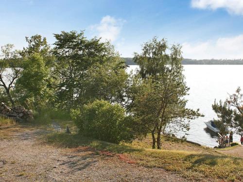 a view of a lake with a boat in the water at 4 person holiday home in STENHAMRA in Stenhamra