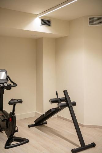 a room with a gym with a treadmill at Stefan Village Hotel in Agia Marina Nea Kydonias