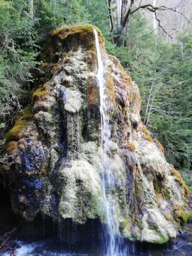 a waterfall on a rock in the middle of a river at Logis Hostellerie Du Grand Duc hôtel restaurant in Gincla
