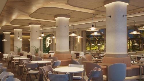 a restaurant with tables and chairs in a building at Port Benidorm Hotel & Spa 4* Sup in Benidorm
