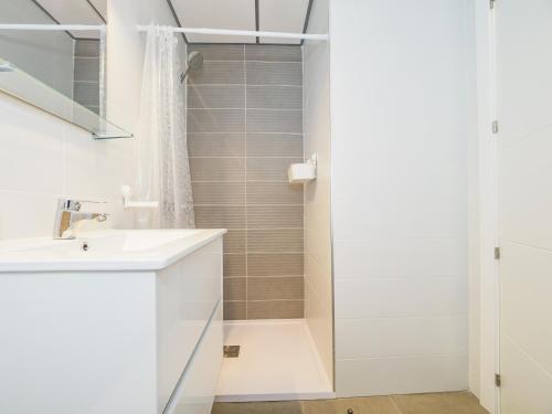 a white bathroom with a shower and a sink at Cubo's Marques Apartment with Free Parking in Almayate Alto