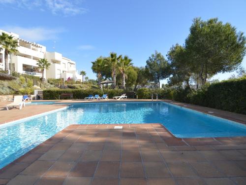 a swimming pool in a villa with palm trees at Golfside Luxury at Las Colinas in Orihuela Costa