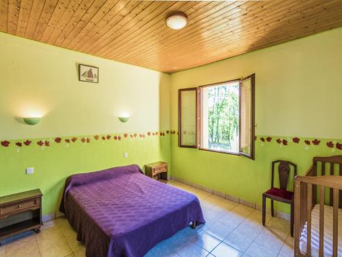 a bedroom with a purple bed and a window at Quiet holiday home with shared pool in Salignac