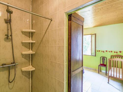 a bathroom with a shower and a glass door at Quiet holiday home with shared pool in Salignac