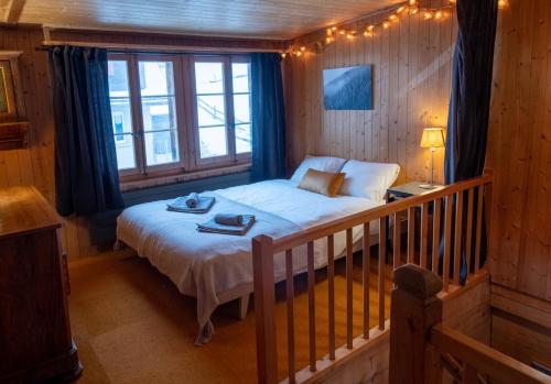 a bedroom with a bed in a wooden room at Cozy chalet in Kandersteg in Kandersteg