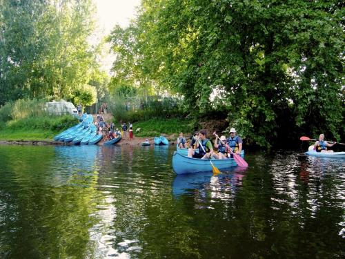 a group of people riding in canoes on a river at Quiet holiday home with shared pool in Salignac