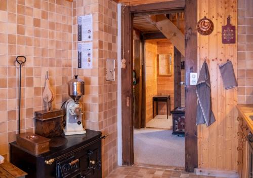an entrance to a kitchen with a brick wall at Cozy chalet in Kandersteg in Kandersteg