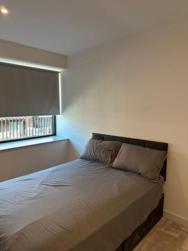 a small bedroom with a bed with a window at Royal docks in London