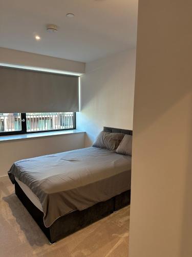 a bed in a bedroom with a window at Royal docks in London