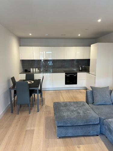 a living room with a blue couch and a table at Royal docks in London