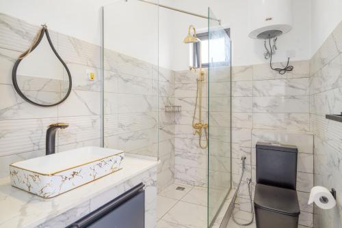 a bathroom with a sink and a glass shower at Villa Familiale Luxe Piscine Privée Toit-Terrasse in Balaclava