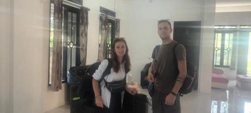 a man and a woman standing in a room at Sony homestay in Komodo Labuan Bajo Airport