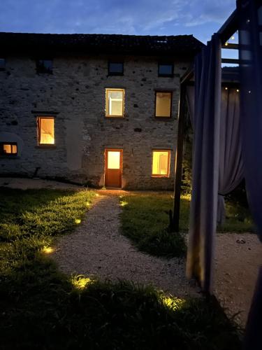 a stone house with a door in the night at La finestra sul grappa in Seren del Grappa