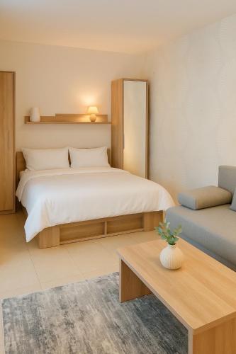 a bedroom with a large bed and a couch at Domček Lodenica in Šintava
