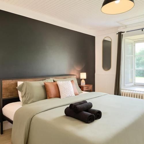 a bedroom with a large bed with two towels on it at Le petit d'Antan Parking 10 min from the center in Quebec City