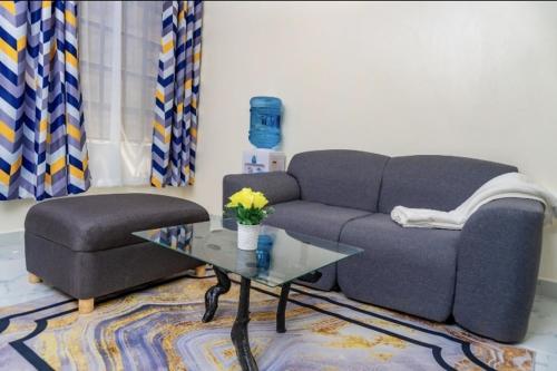 a living room with a couch and a coffee table at Carsons Nest BnB in Narok