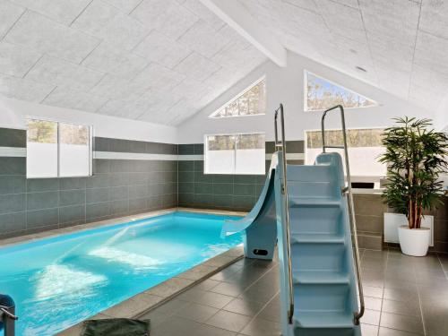 a swimming pool with an escalator in a building at 5 star holiday home in Frederiksværk in Frederiksværk