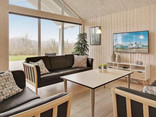a living room with a couch and a table at 5 star holiday home in Kappeln in Kappeln