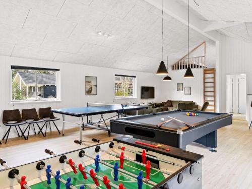a living room with a pool table and ping pong tables at 5 star holiday home in Frederiksværk in Frederiksværk