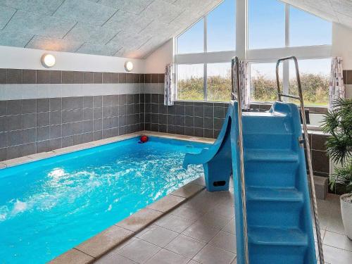 a swimming pool with a slide in a house at 5 star holiday home in Kappeln in Kappeln
