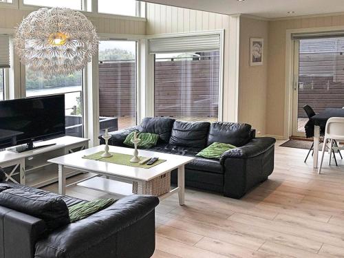 a living room with a couch and a table at 4 star holiday home in Lyngdal in Lyngdal