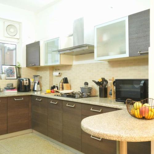 a kitchen with a table and a counter top at have fun staying here in Kuala Lumpur