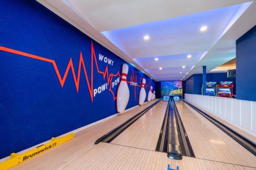 a hallway with a bowling alley with pins in it at Kandima Maldives in Kudahuvadhoo