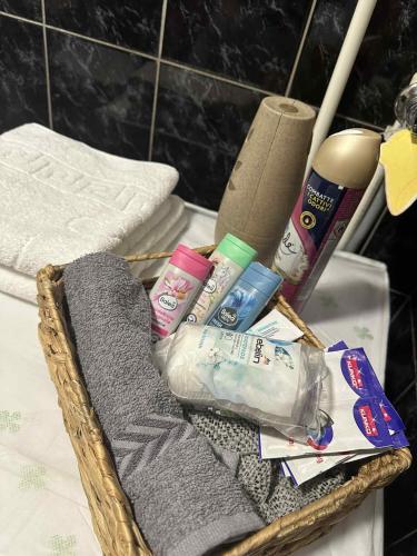 a basket with towels and toothbrushes and toothpaste at Villa 17 in Gevgelija