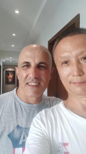 two men are standing next to each other at 梦境酒店壹号客栈 in Zhangjiajie