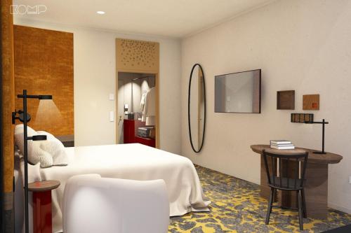 a bedroom with a bed and a table and a chair at Hotel Lycium Debrecen - Handwritten Collection (October 2025) in Debrecen