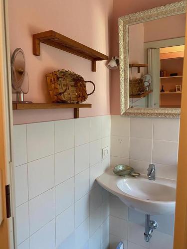 a bathroom with a sink and a mirror at Maggie House by GHOR in Rome