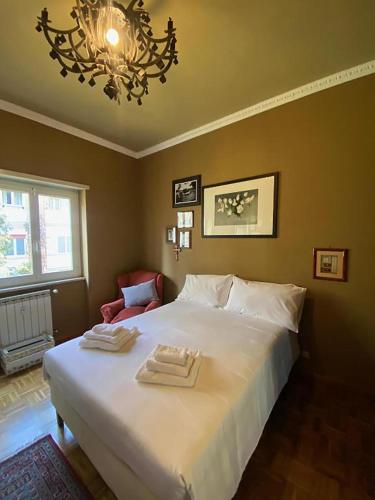 a bedroom with a large bed with two towels on it at Maggie House by GHOR in Rome