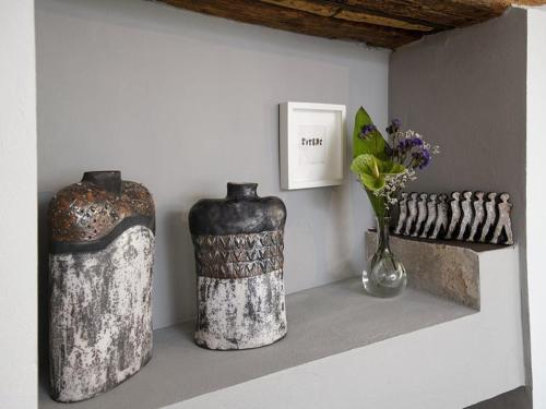 two vases sitting on a shelf in a room at Holiday Home in Vodnjan near the Sea in Vodnjan
