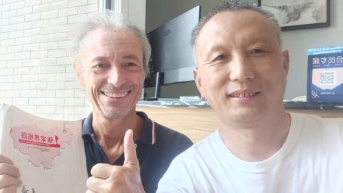 two men posing for a picture while holding a map at 梦境酒店壹号客栈 in Zhangjiajie