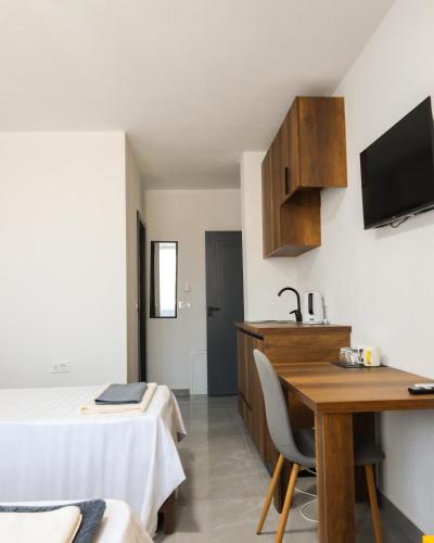 a room with a bed and a desk and a sink at Nuvelle Boutique Hotel in Prizren