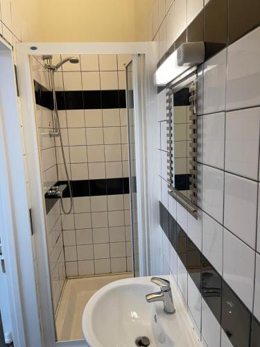 a bathroom with a sink and a shower at Penzance Central 1 & 2 Bedroom flats in Penzance